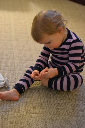 Picking her toe jam. 